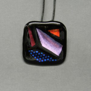 Black Dichroic Glass Pendant with tiny blue polka dots, red, pig and orange areas